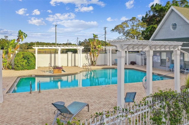 community pool featuring a pergola, fence, and a patio area