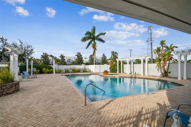 community pool featuring a pergola, a fenced backyard, and a patio