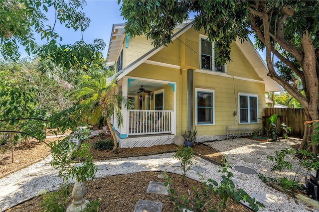 1038 Crescent Lake Dr N, Saint Petersburg, FL 33701 - view of front of house with a porch, fence, and a ceiling fan