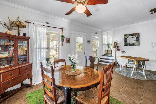 1038 Crescent Lake Dr N, Saint Petersburg, FL 33701 - dining area featuring tile patterned flooring, crown molding, ceiling fan, and baseboards