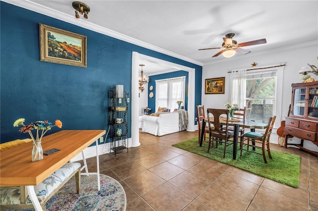 1038 Crescent Lake Dr N, Saint Petersburg, FL 33701 - dining area featuring healthy amount of natural light, ornamental molding, tile patterned flooring, ceiling fan, and baseboards