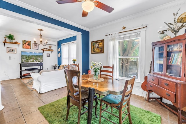 1038 Crescent Lake Dr N, Saint Petersburg, FL 33701 - dining area with light tile patterned floors, crown molding, a chandelier, and a ceiling fan