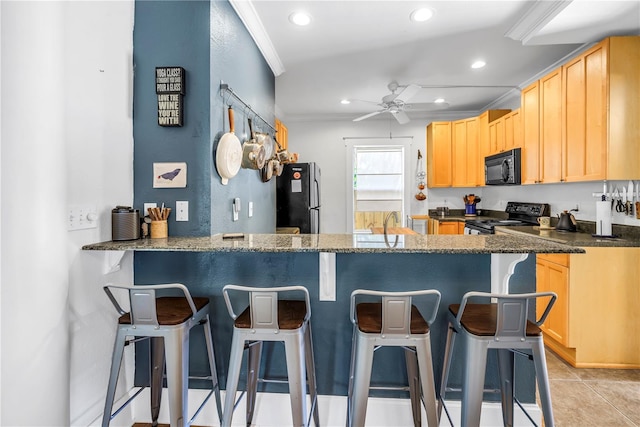 1038 Crescent Lake Dr N, Saint Petersburg, FL 33701 - kitchen with black appliances, light brown cabinetry, a ceiling fan, recessed lighting, and a peninsula
