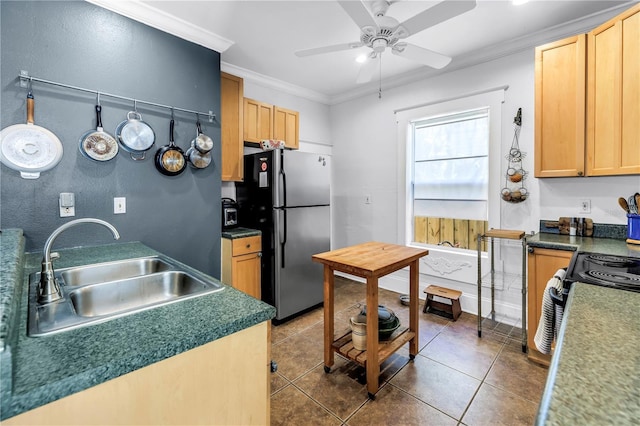 1038 Crescent Lake Dr N, Saint Petersburg, FL 33701 - kitchen with freestanding refrigerator, a sink, ornamental molding, a ceiling fan, and tile patterned floors