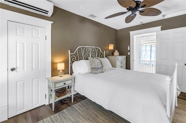 1038 Crescent Lake Dr N, Saint Petersburg, FL 33701 - bedroom with an AC wall unit, wood finished floors, and ceiling fan