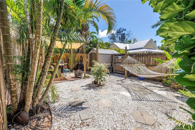 1038 Crescent Lake Dr N, Saint Petersburg, FL 33701 - fenced backyard featuring a shed, a patio, and an outbuilding