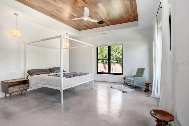 bedroom featuring wood ceiling, concrete flooring, baseboards, and a raised ceiling