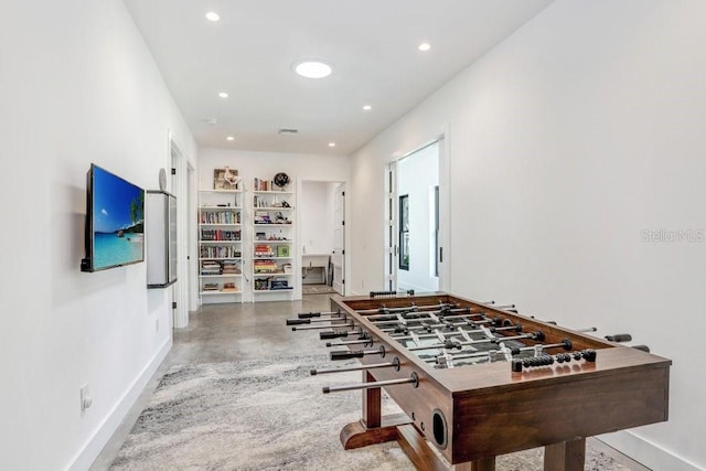 playroom featuring finished concrete floors, baseboards, and recessed lighting