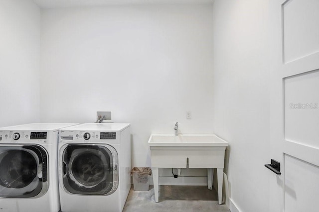 clothes washing area featuring washer and dryer