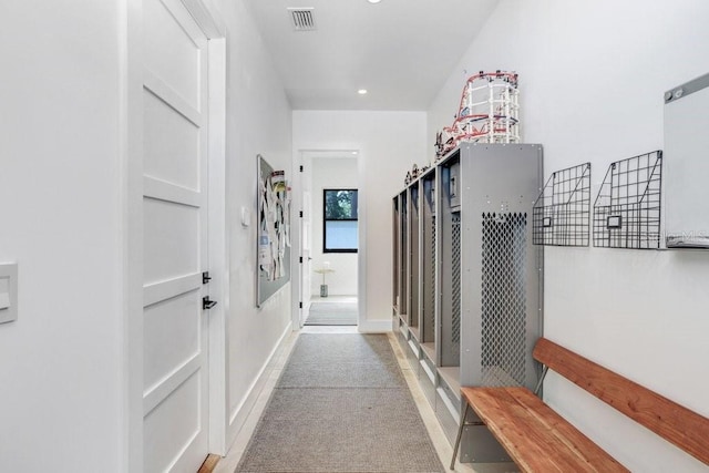 corridor featuring built in features, recessed lighting, and carpet