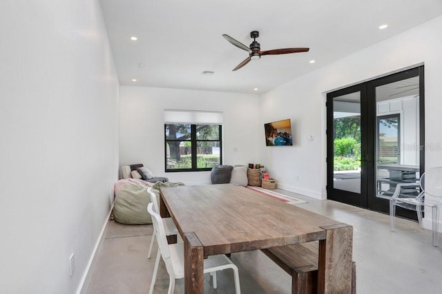 dining area featuring french doors, concrete floors, baseboards, and recessed lighting