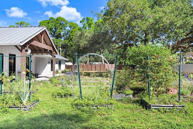 view of yard featuring a vegetable garden and fence