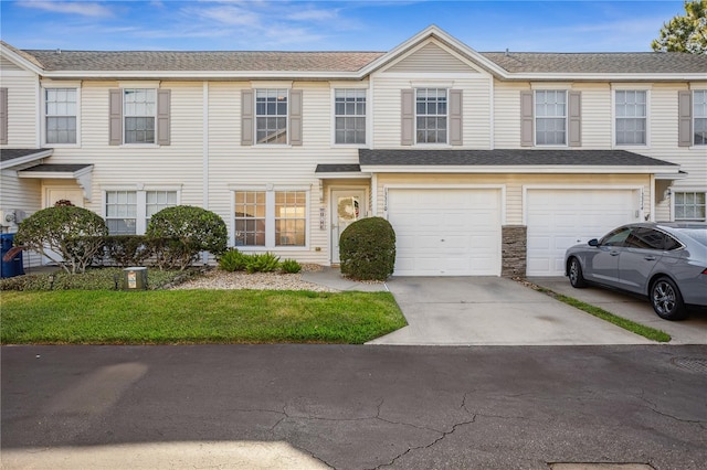 view of property with driveway and a garage