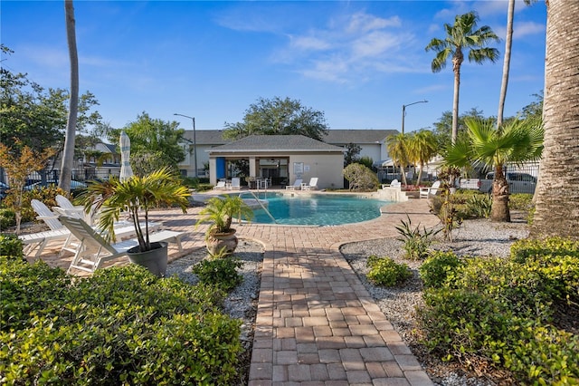 community pool featuring a patio area and fence