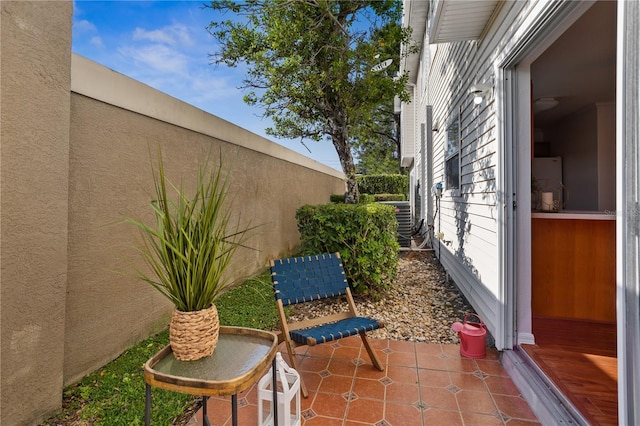 view of side of property featuring stucco siding and a patio area
