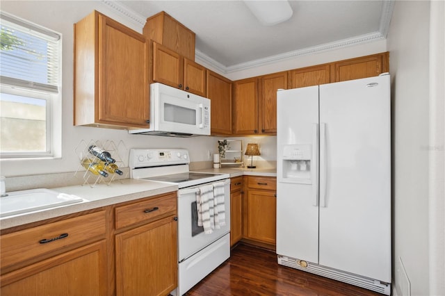 kitchen with white appliances, light countertops, dark wood-style floors, a sink, and brown cabinetry