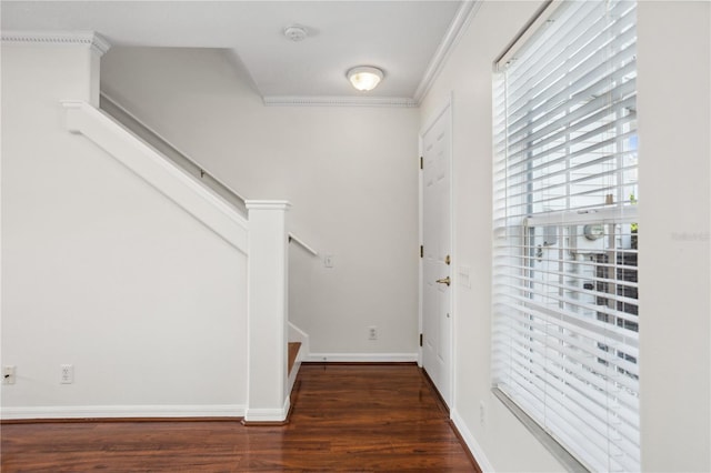 foyer entrance with crown molding, wood finished floors, stairway, and baseboards
