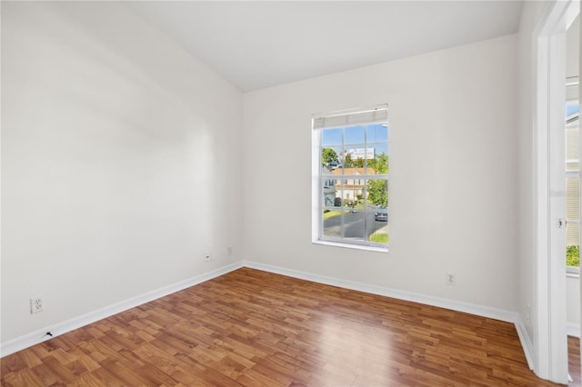 unfurnished room with wood finished floors and baseboards
