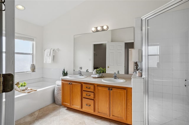 full bathroom with a bath, tile patterned flooring, double vanity, a shower stall, and lofted ceiling