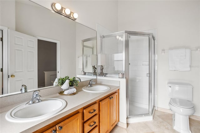 bathroom featuring a shower stall, tile patterned floors, double vanity, and toilet