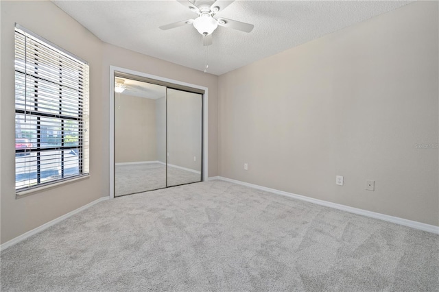 5100 Burchette Rd Unit 3005, Tampa, FL 33647 - unfurnished bedroom featuring carpet, baseboards, a ceiling fan, a closet, and a textured ceiling