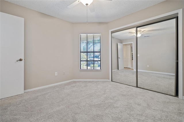 5100 Burchette Rd Unit 3005, Tampa, FL 33647 - unfurnished bedroom with carpet floors, a closet, a textured ceiling, a ceiling fan, and baseboards