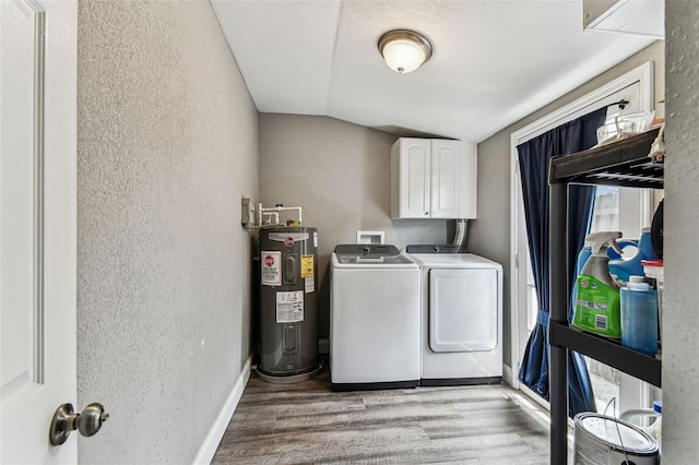 4465 56th Ave N, Saint Petersburg, FL 33714 - washroom with electric water heater, cabinet space, washing machine and clothes dryer, light wood-type flooring, and a textured wall