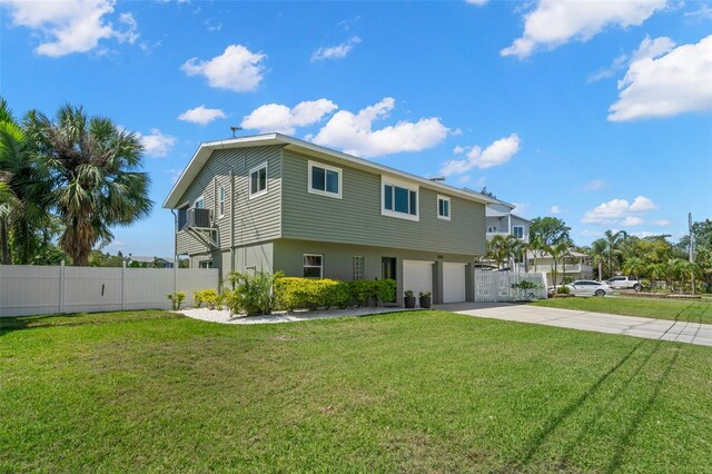 261 Kentucky Ave, Crystal Beach, FL 34681 - view of front of home with an attached garage, cooling unit, and concrete driveway