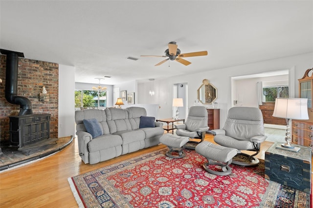 261 Kentucky Ave, Crystal Beach, FL 34681 - living area with ceiling fan, wood finished floors, and a wood stove