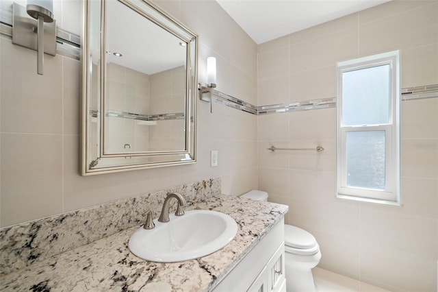 261 Kentucky Ave, Crystal Beach, FL 34681 - bathroom with vanity, tile walls, and toilet