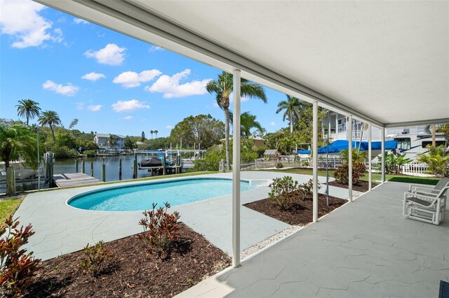 261 Kentucky Ave, Crystal Beach, FL 34681 - outdoor pool featuring boat lift, a water view, a patio, and a boat dock