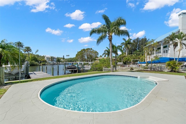 261 Kentucky Ave, Crystal Beach, FL 34681 - swimming pool with boat lift, a boat dock, a water view, and fence