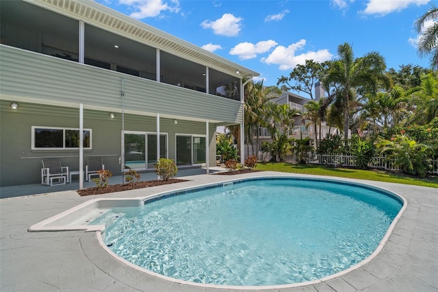 261 Kentucky Ave, Crystal Beach, FL 34681 - swimming pool featuring a sunroom, a patio area, and fence