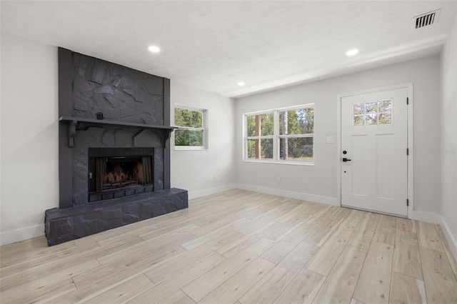 2157 20th Ave SW, Largo, FL 33774 - unfurnished living room with wood finished floors, recessed lighting, a fireplace, and baseboards