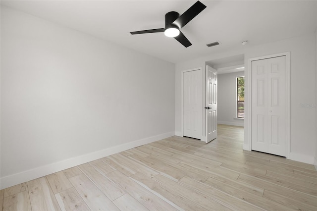 2157 20th Ave SW, Largo, FL 33774 - unfurnished room with light wood-type flooring, baseboards, and a ceiling fan