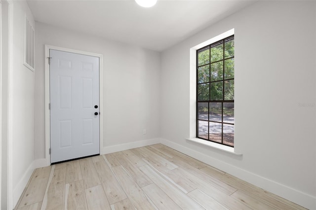 2157 20th Ave SW, Largo, FL 33774 - foyer entrance with light wood-style floors and baseboards