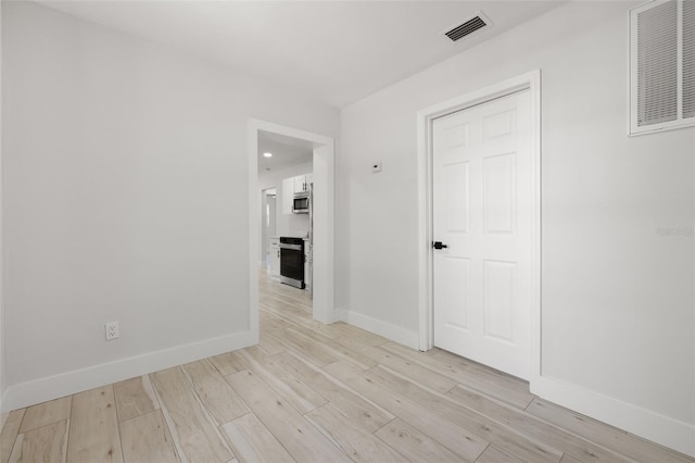 2157 20th Ave SW, Largo, FL 33774 - spare room featuring baseboards and light wood-style flooring
