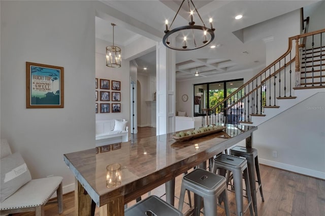 dining room with a chandelier, coffered ceiling, stairs, dark wood finished floors, and baseboards