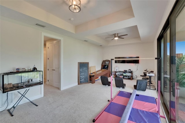 bedroom featuring carpet floors, a raised ceiling, and baseboards