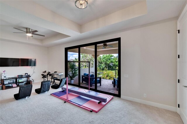 workout room with a ceiling fan, carpet flooring, and baseboards