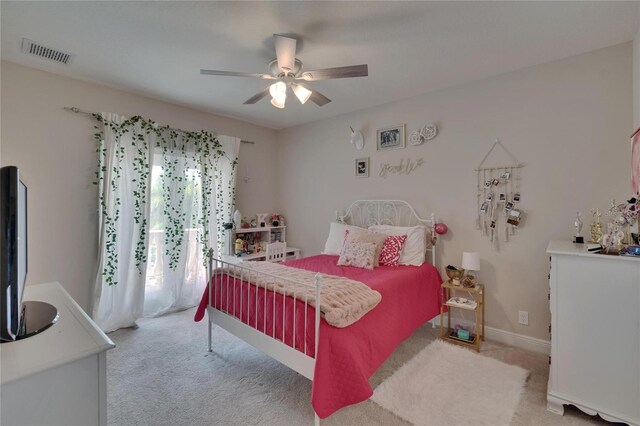 carpeted bedroom featuring ceiling fan and baseboards