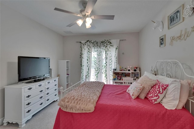 bedroom featuring light carpet and a ceiling fan