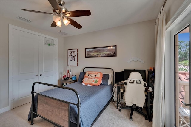 bedroom featuring light carpet, ceiling fan, a closet, and baseboards