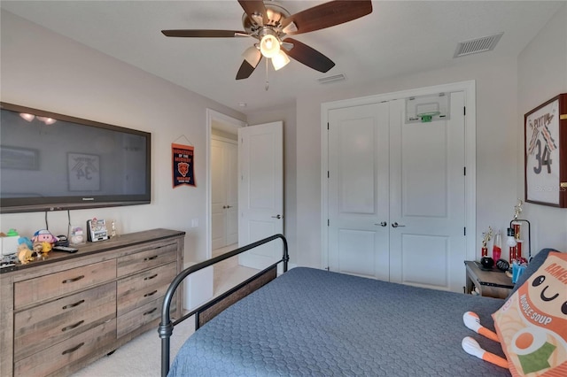 carpeted bedroom featuring a closet and a ceiling fan