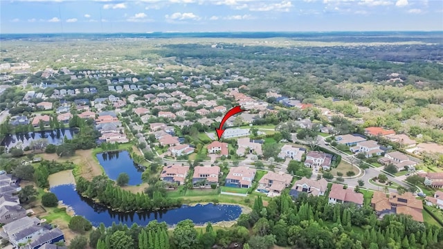 aerial view of property's location featuring nearby suburban area and a large body of water