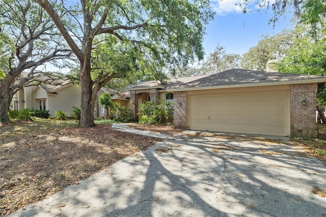 6237 Greenwich Dr, Tampa, FL 33647 - single story home with brick siding, driveway, an attached garage, and a chimney