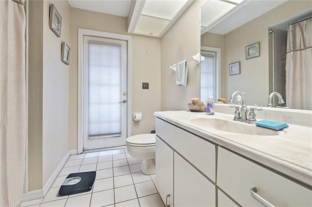 6237 Greenwich Dr, Tampa, FL 33647 - bathroom with tile patterned floors, toilet, vanity, and baseboards
