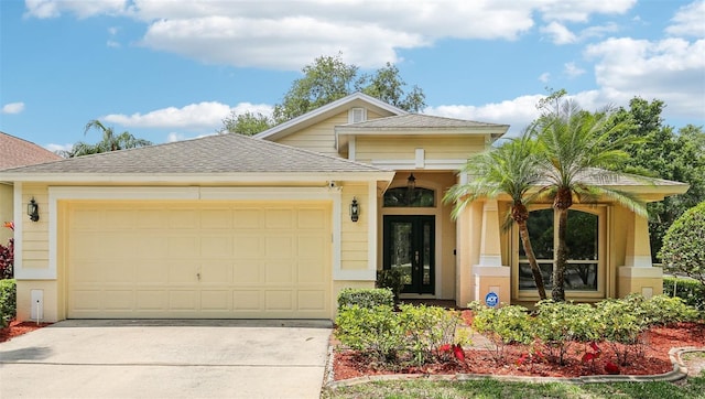 10150 Heather Sound Dr, Tampa, FL 33647 - view of front facade featuring an attached garage, driveway, and roof with shingles