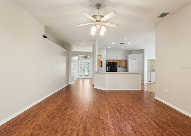 10150 Heather Sound Dr, Tampa, FL 33647 - unfurnished living room with independent washer and dryer, wood finished floors, a ceiling fan, baseboards, and recessed lighting