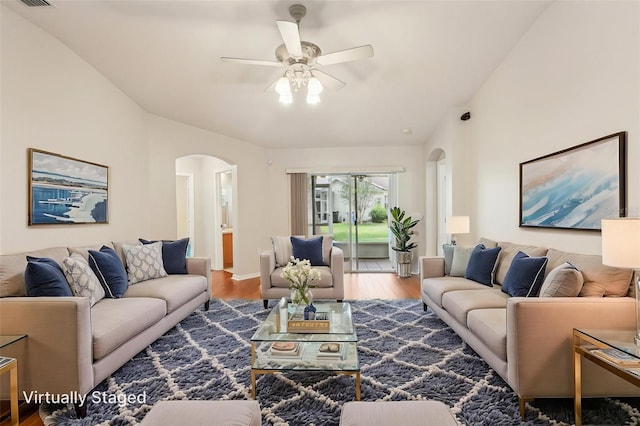 10150 Heather Sound Dr, Tampa, FL 33647 - living room featuring arched walkways, wood finished floors, and a ceiling fan